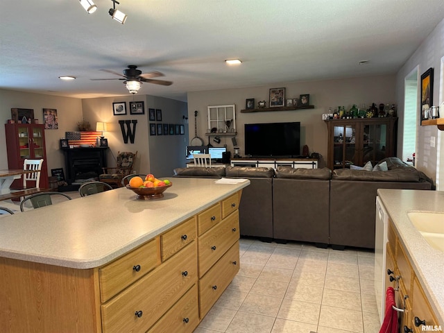 kitchen featuring light tile patterned flooring, a center island, rail lighting, and ceiling fan