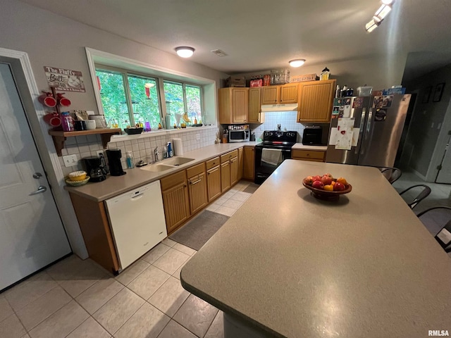 kitchen featuring light tile patterned flooring, sink, tasteful backsplash, and stainless steel appliances