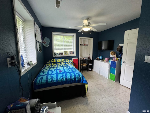 bedroom featuring light tile patterned flooring and ceiling fan