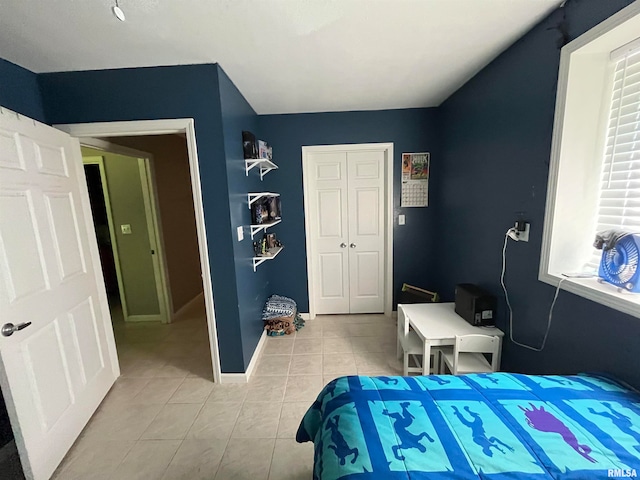 bedroom featuring a closet and light tile patterned floors