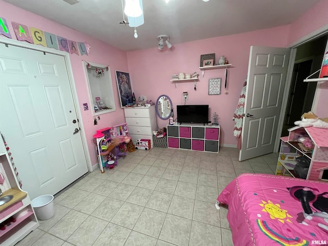 bedroom featuring light tile patterned floors and ceiling fan