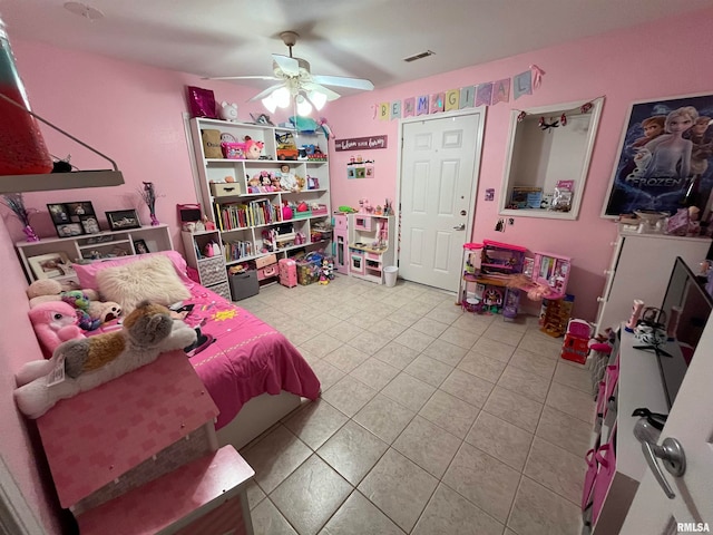 bedroom with ceiling fan and light tile patterned floors