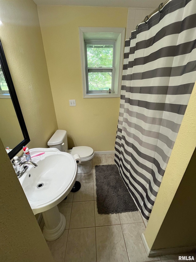 bathroom featuring tile patterned flooring, toilet, and sink