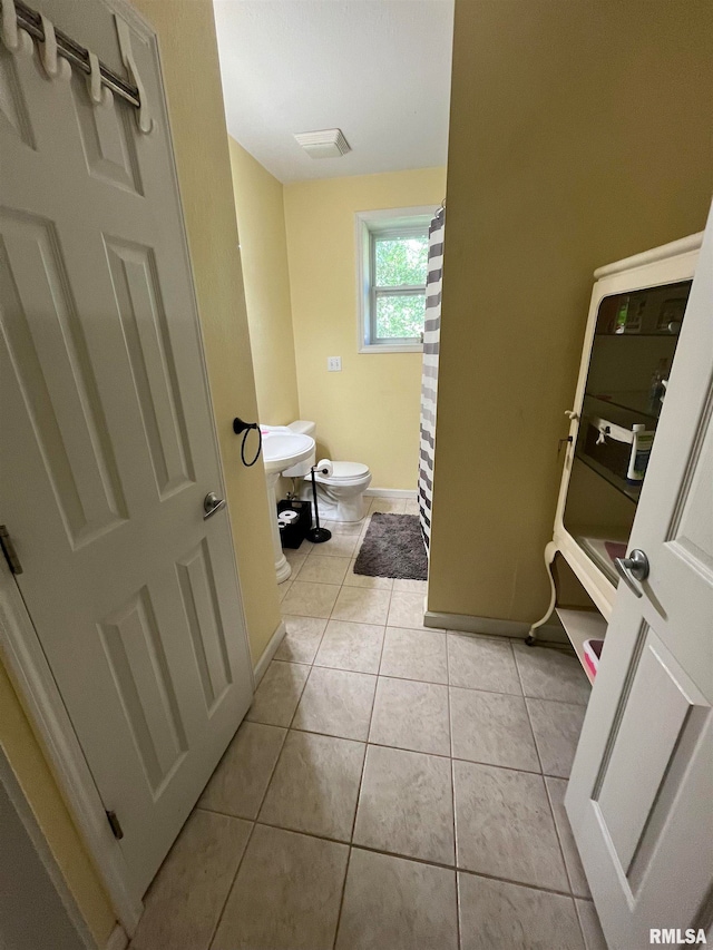 bathroom featuring tile patterned flooring and toilet