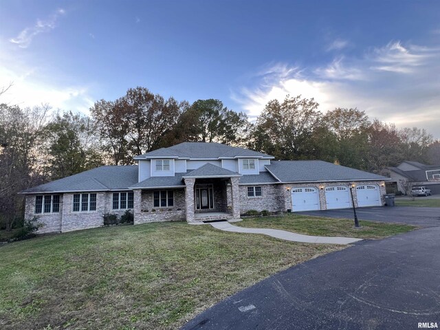 view of front of home with a front yard and a garage