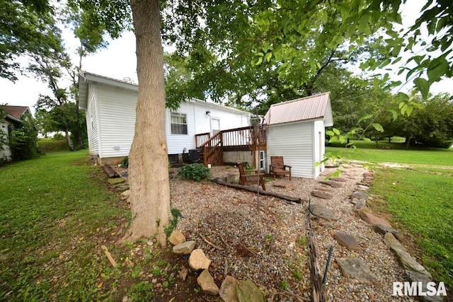 rear view of property with a lawn and a wooden deck