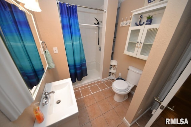 bathroom featuring a shower with shower curtain, vanity, tile patterned floors, and toilet