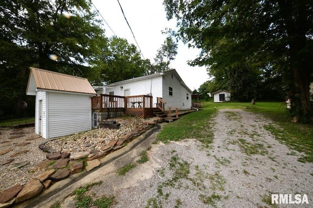 804 Williams St, Mount Vernon, IL 62864 - view of home's exterior with a wooden deck, metal roof, and dirt driveway