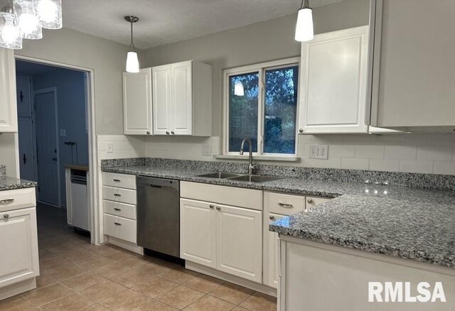 kitchen with light tile patterned floors, white cabinetry, sink, and stainless steel dishwasher