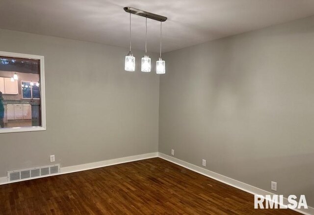 unfurnished room featuring dark wood-type flooring