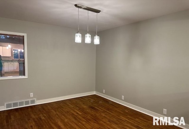 spare room featuring dark hardwood / wood-style flooring