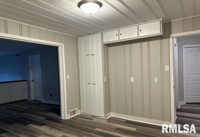 interior space with ornamental molding and hardwood / wood-style flooring