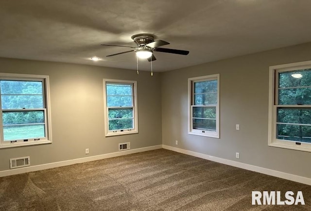 carpeted empty room with a healthy amount of sunlight and ceiling fan