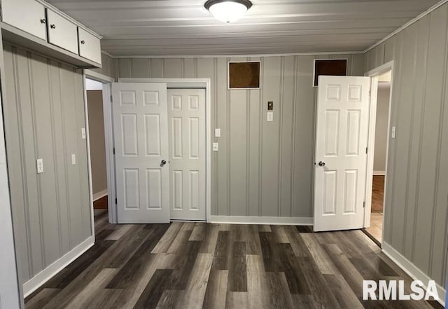 unfurnished bedroom with a closet and dark wood-type flooring