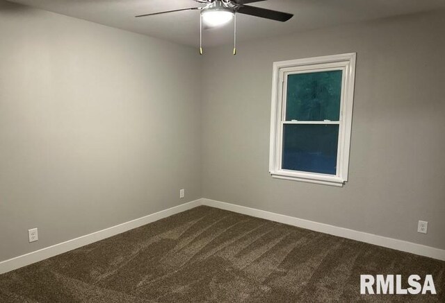 spare room featuring carpet floors and ceiling fan