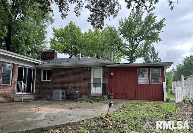 back of house featuring central AC unit