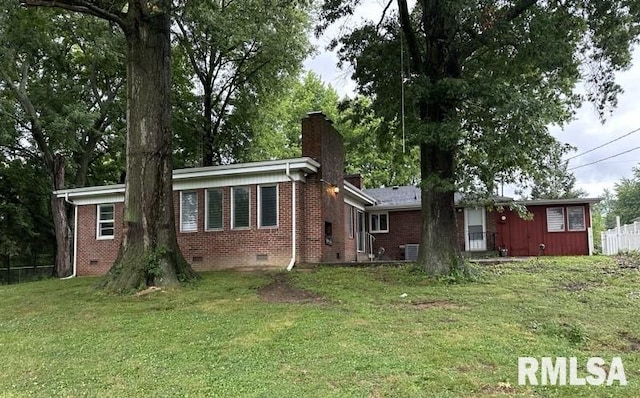 rear view of house featuring a yard