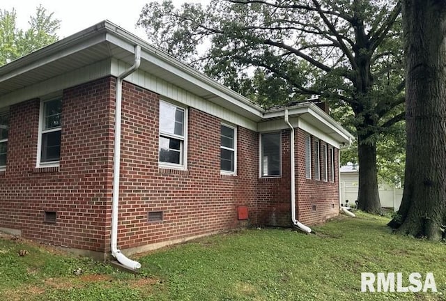 view of side of home featuring a lawn