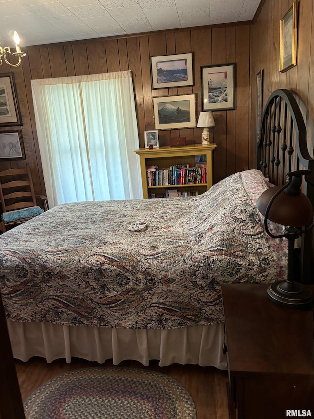 bedroom with wood walls