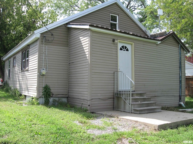 back of property with a lawn