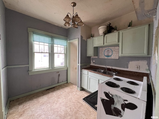 kitchen with pendant lighting, sink, green cabinets, white range with electric stovetop, and a notable chandelier