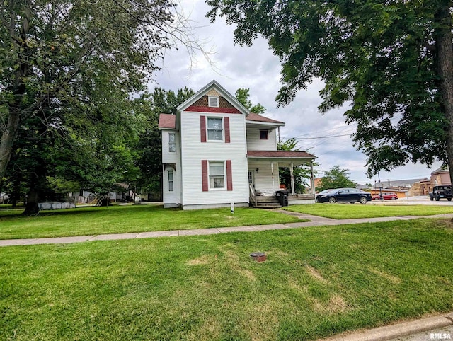 victorian-style house featuring a front lawn