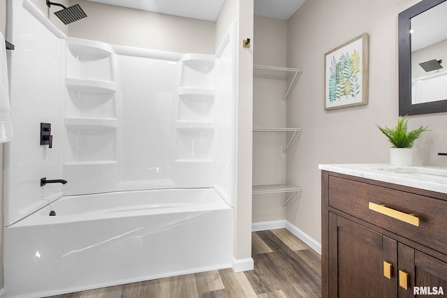 bathroom with vanity, shower / washtub combination, and hardwood / wood-style floors