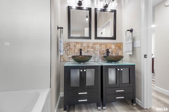 bathroom with tasteful backsplash, vanity, and hardwood / wood-style floors