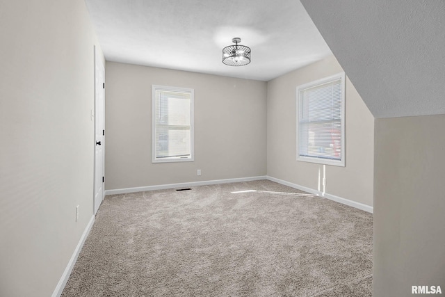 spare room with carpet floors and a textured ceiling