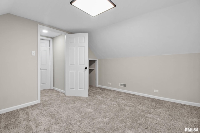 bonus room featuring light carpet and lofted ceiling