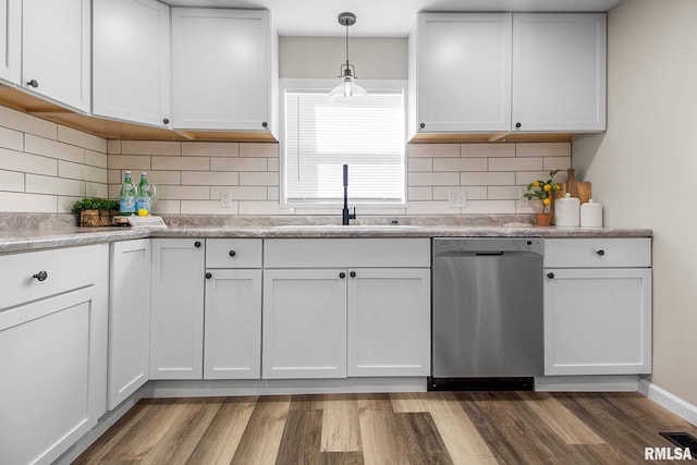 kitchen featuring pendant lighting, sink, dishwasher, white cabinetry, and dark hardwood / wood-style floors