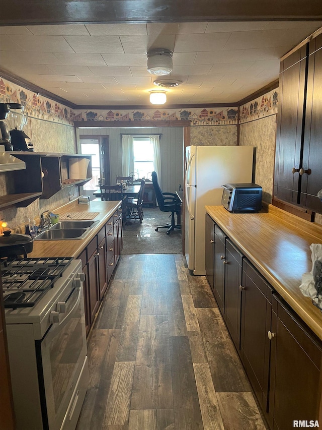 kitchen featuring dark brown cabinetry, sink, dark wood-type flooring, and range with gas stovetop