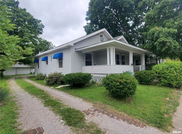 view of side of property with a porch and a yard