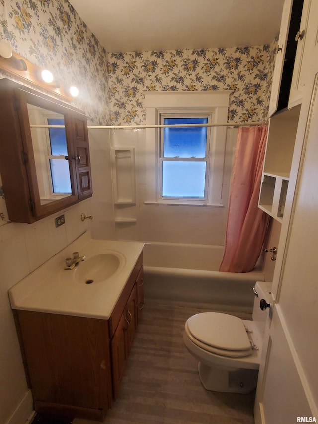 full bathroom featuring hardwood / wood-style flooring, vanity, toilet, and shower / bath combo