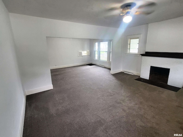 unfurnished living room featuring dark carpet, a fireplace, and ceiling fan