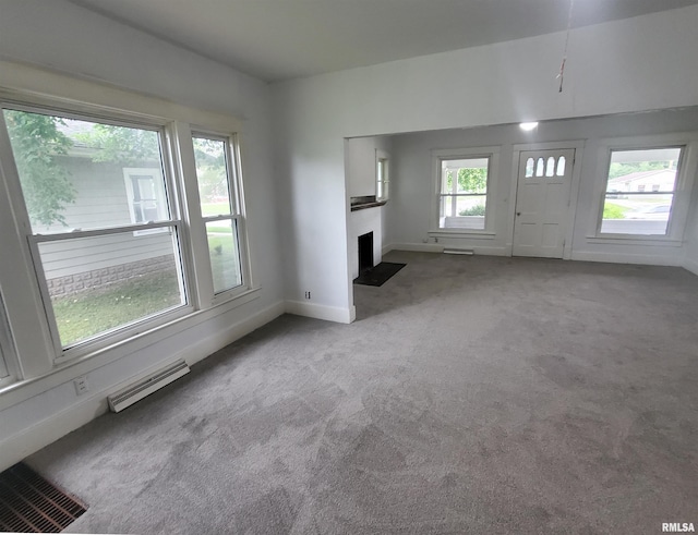 unfurnished living room with light colored carpet