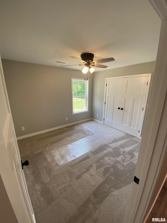 interior space with ceiling fan and carpet