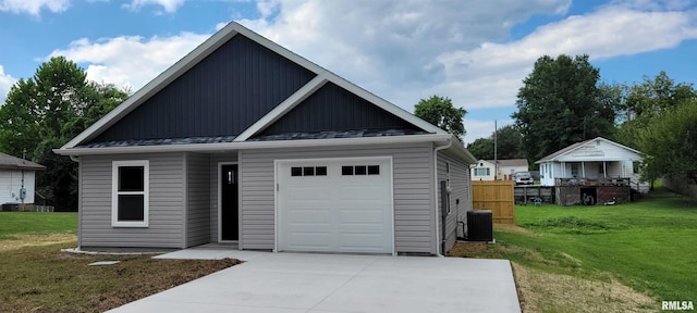 garage with a yard and central air condition unit