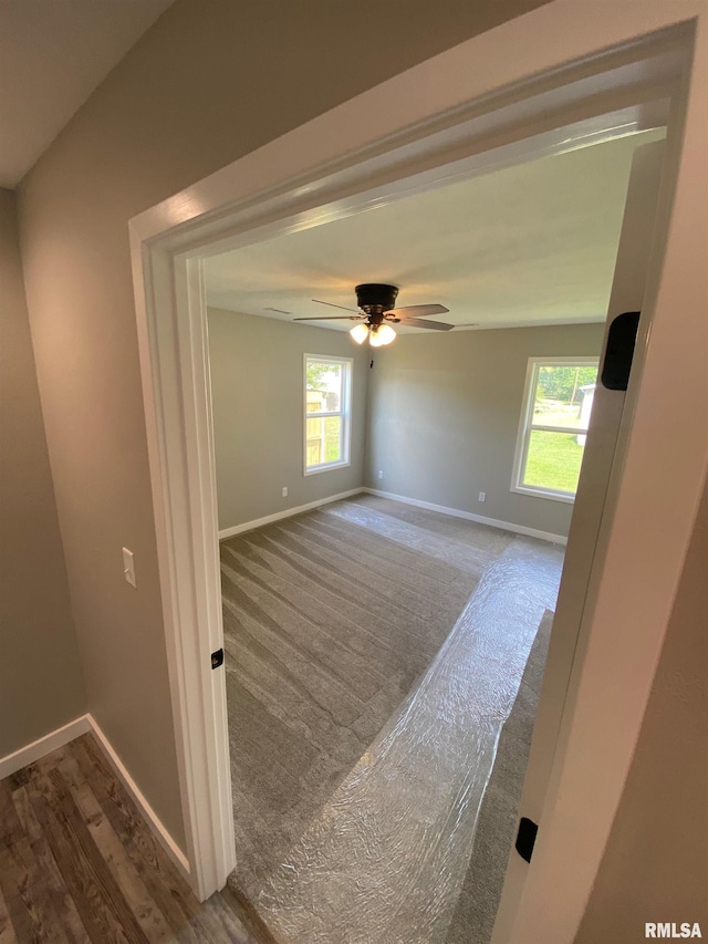 spare room featuring ceiling fan, vaulted ceiling, and wood-type flooring