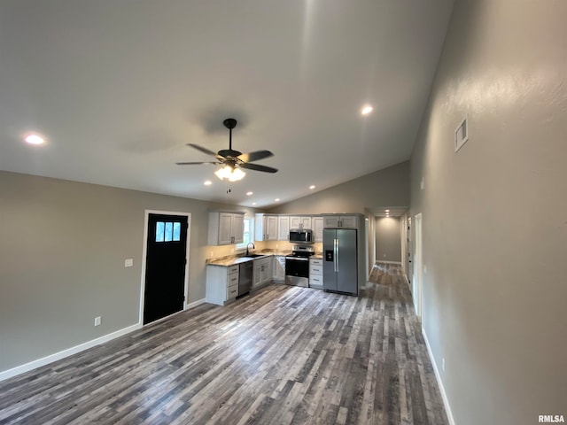 kitchen featuring ceiling fan, lofted ceiling, gray cabinetry, stainless steel appliances, and dark hardwood / wood-style flooring