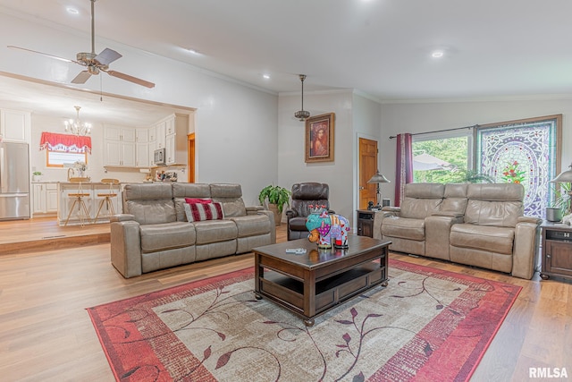 living room with ceiling fan with notable chandelier, crown molding, lofted ceiling, and light hardwood / wood-style floors