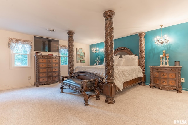 bedroom featuring a notable chandelier, carpet flooring, and ornate columns