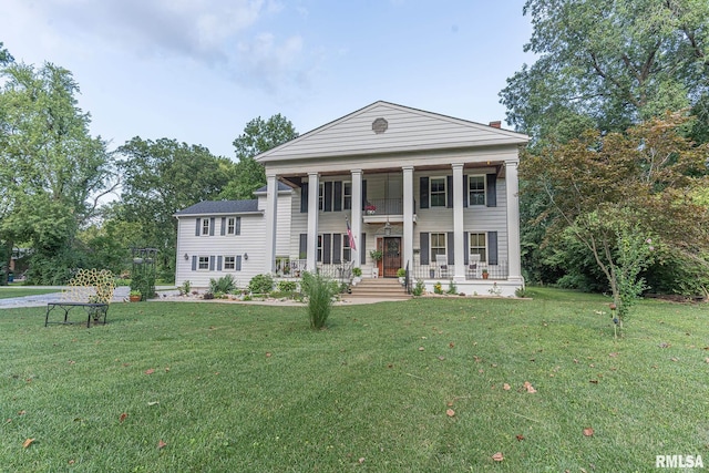 greek revival house with covered porch and a front yard