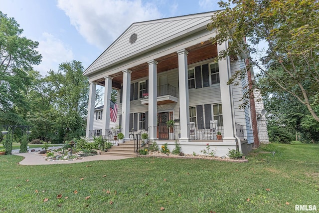 neoclassical / greek revival house with covered porch and a front lawn