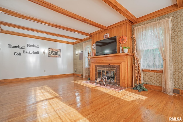 unfurnished living room featuring beam ceiling and hardwood / wood-style floors