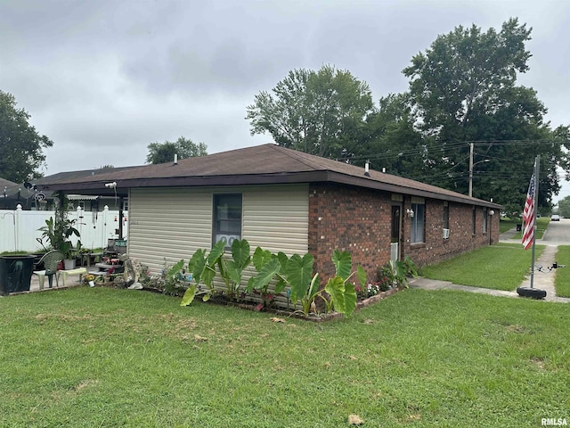 view of home's exterior with a lawn