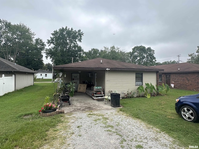 rear view of property featuring a yard and a carport