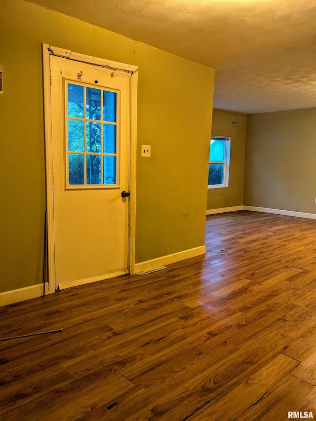 empty room with wood-type flooring