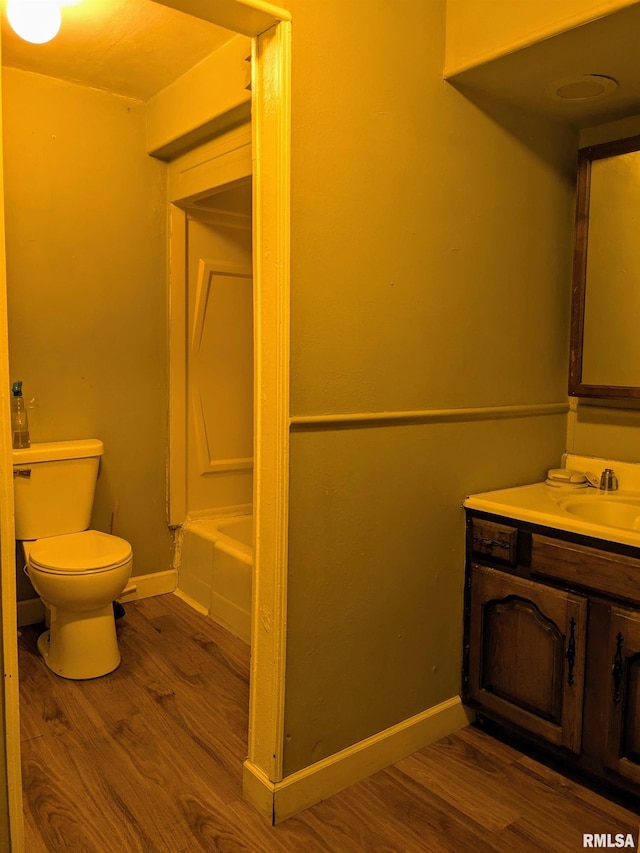 full bathroom featuring shower / bath combination, wood-type flooring, vanity, and toilet