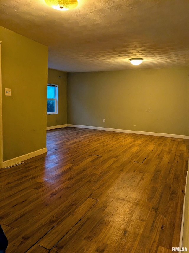 spare room with wood-type flooring